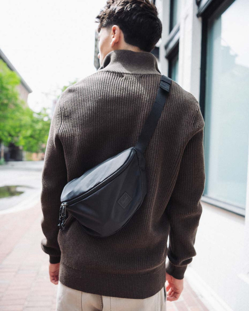 Herschel Supply Co. Kaine Hip Pack in a lifestyle setting, showing the versatile bag worn around the waist or over the shoulder.