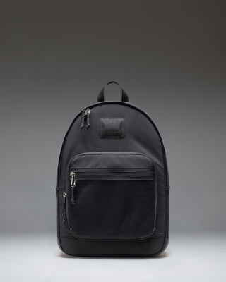 Herschel Supply Co. Kaine Backpack in black, showing the front view with zippered pockets and mesh side pockets.