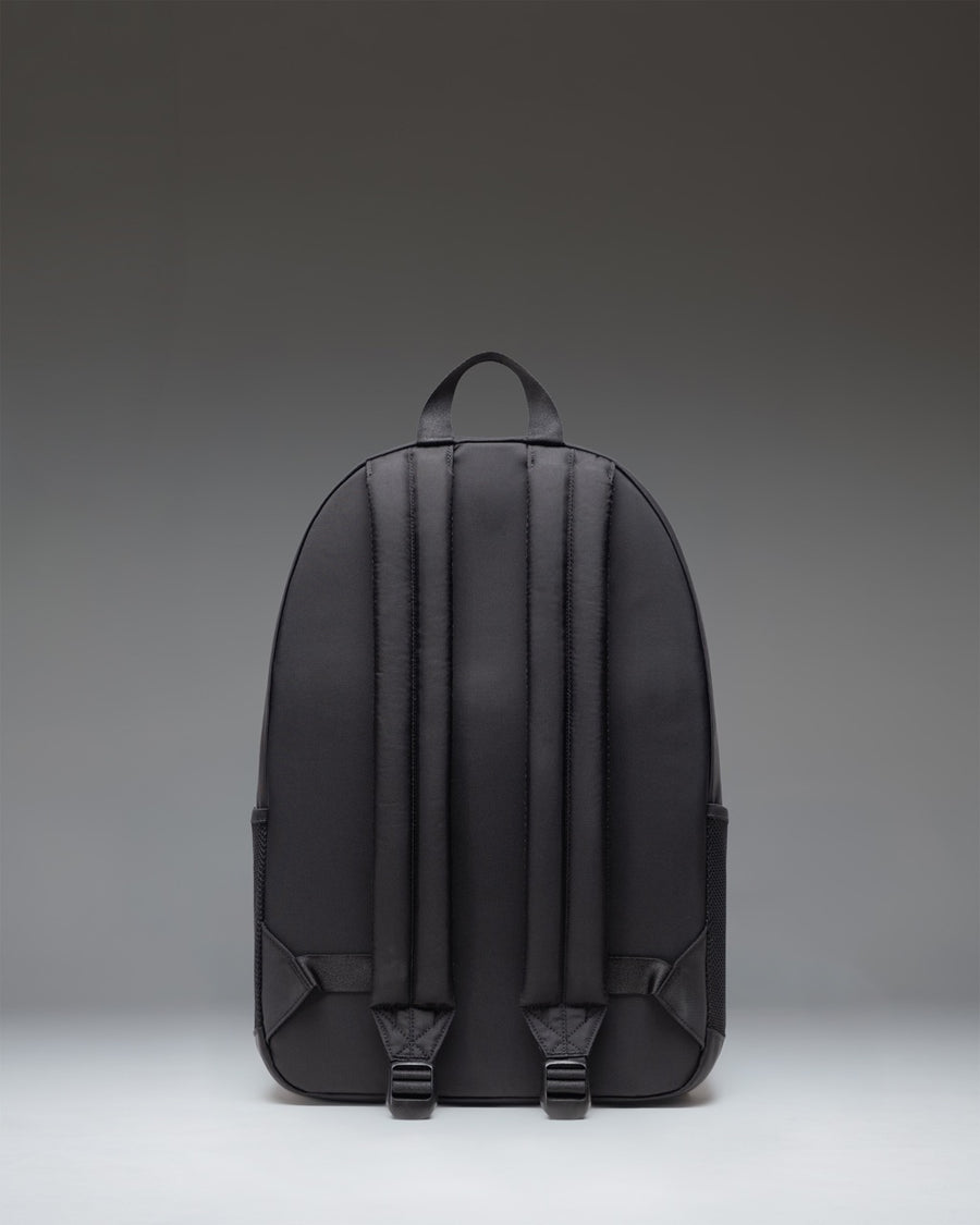 Herschel Supply Co. Kaine Backpack in solid black, showcasing its durable design, multiple compartments, and classic woven label on the front.
