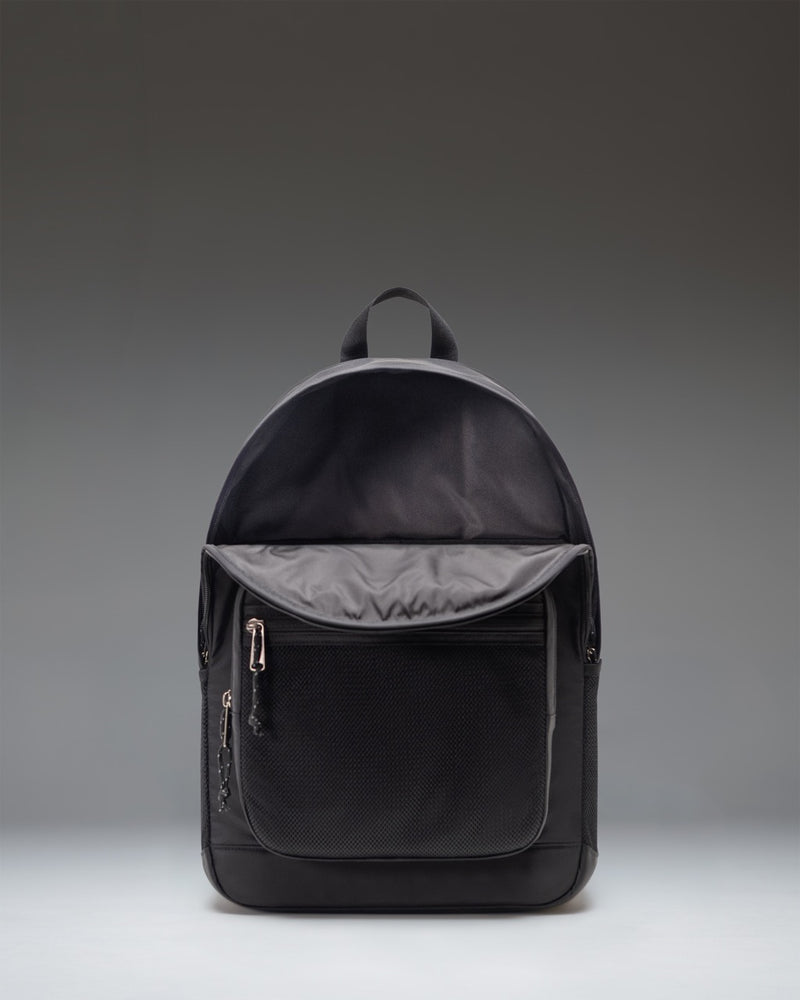 Herschel Supply Co. black Kaine backpack showcasing its rounded top, dual front pockets, and mesh water bottle sleeves.