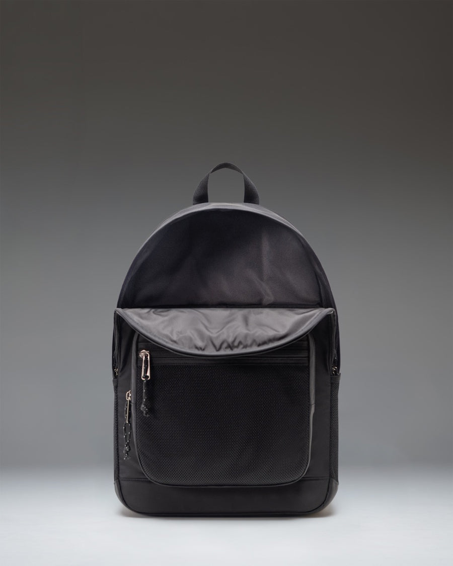 Herschel Supply Co. black Kaine backpack showcasing its rounded top, dual front pockets, and mesh water bottle sleeves.