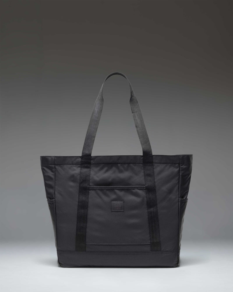 Herschel Heritage Tote Bag in Black, showcasing its classic design and iconic diamond detail on the front.