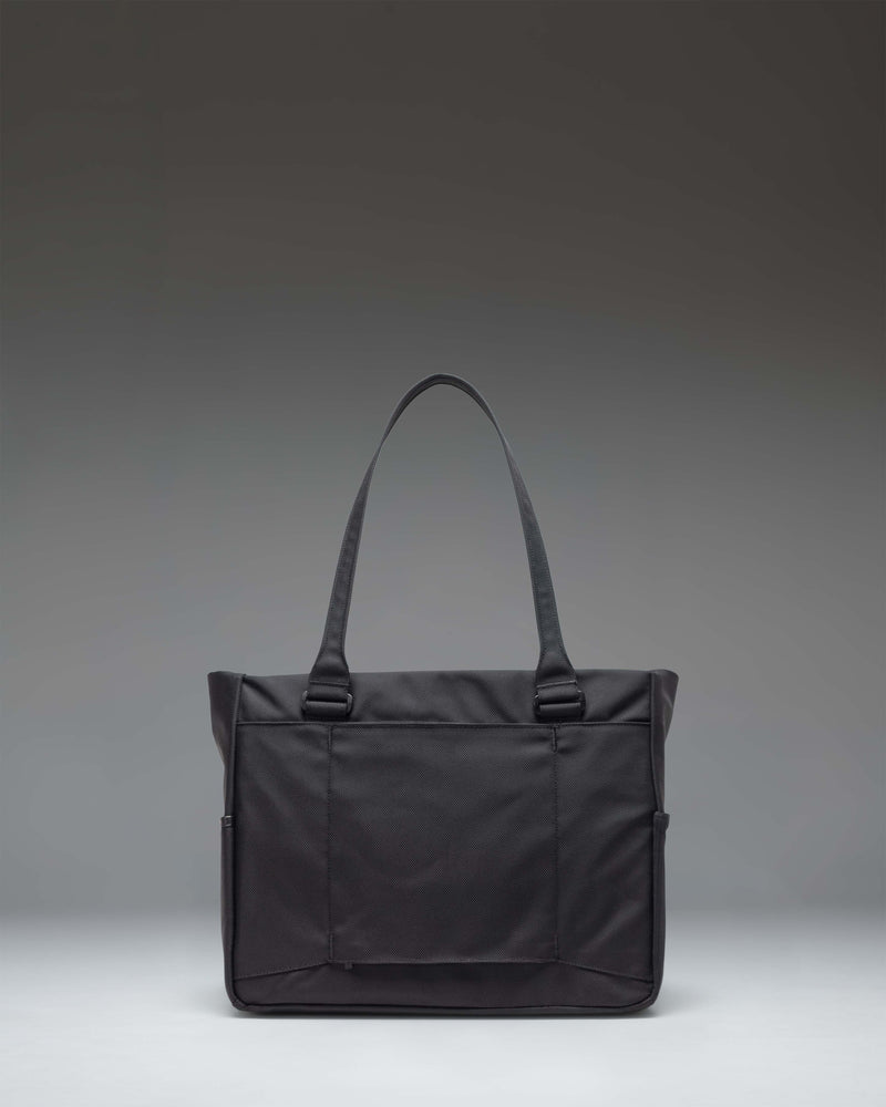 Herschel Supply Co. Kaslo Tote Tech Cordura bag in black, highlighting its durable fabric, convenient top handles, and streamlined design.
