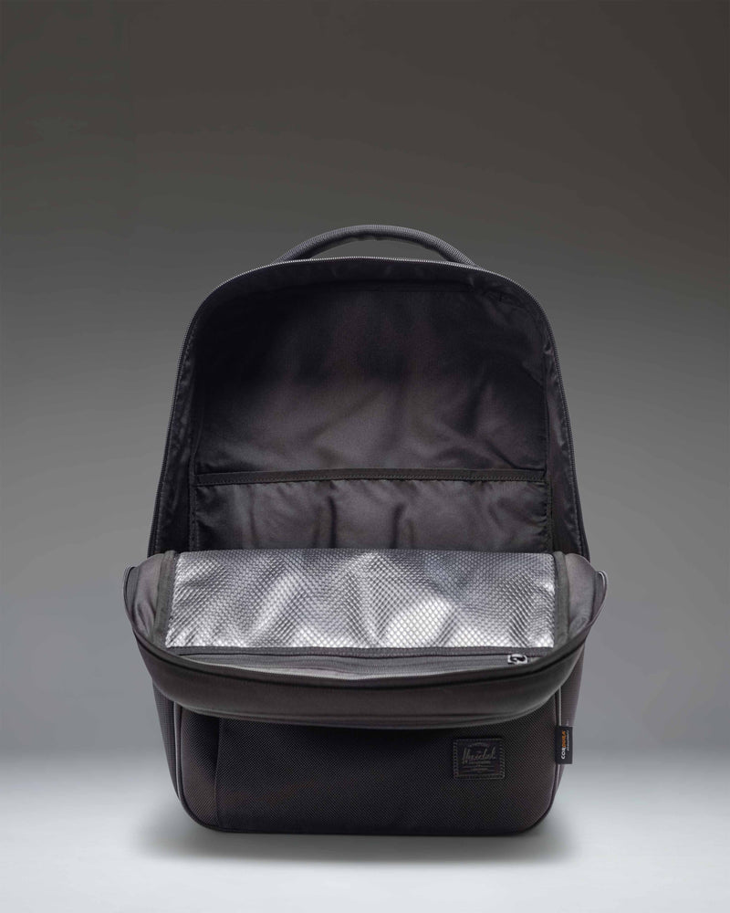 Herschel Supply Co. Kaslo Backpack Tech Cordura in black, showing a detailed side view of the durable fabric, zippers, and contoured shoulder strap.