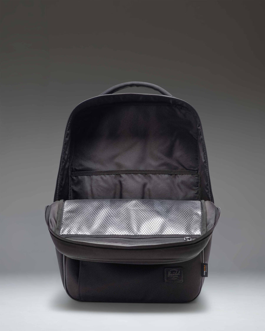 Herschel Supply Co. Kaslo Backpack Tech Cordura in black, showing a detailed side view of the durable fabric, zippers, and contoured shoulder strap.