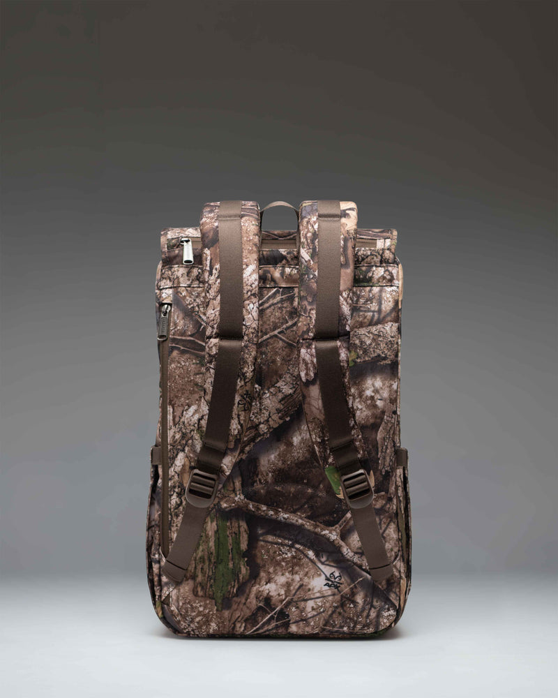 Herschel Supply Co. Little America Backpack in Realtree APX Camo, featuring a classic silhouette with dual magnetic strap closures.