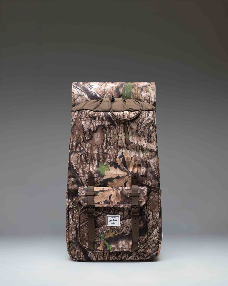 Herschel Supply Co. Realtree Little America Backpack in Realtree APX Camo with signature front straps and a spacious main compartment.