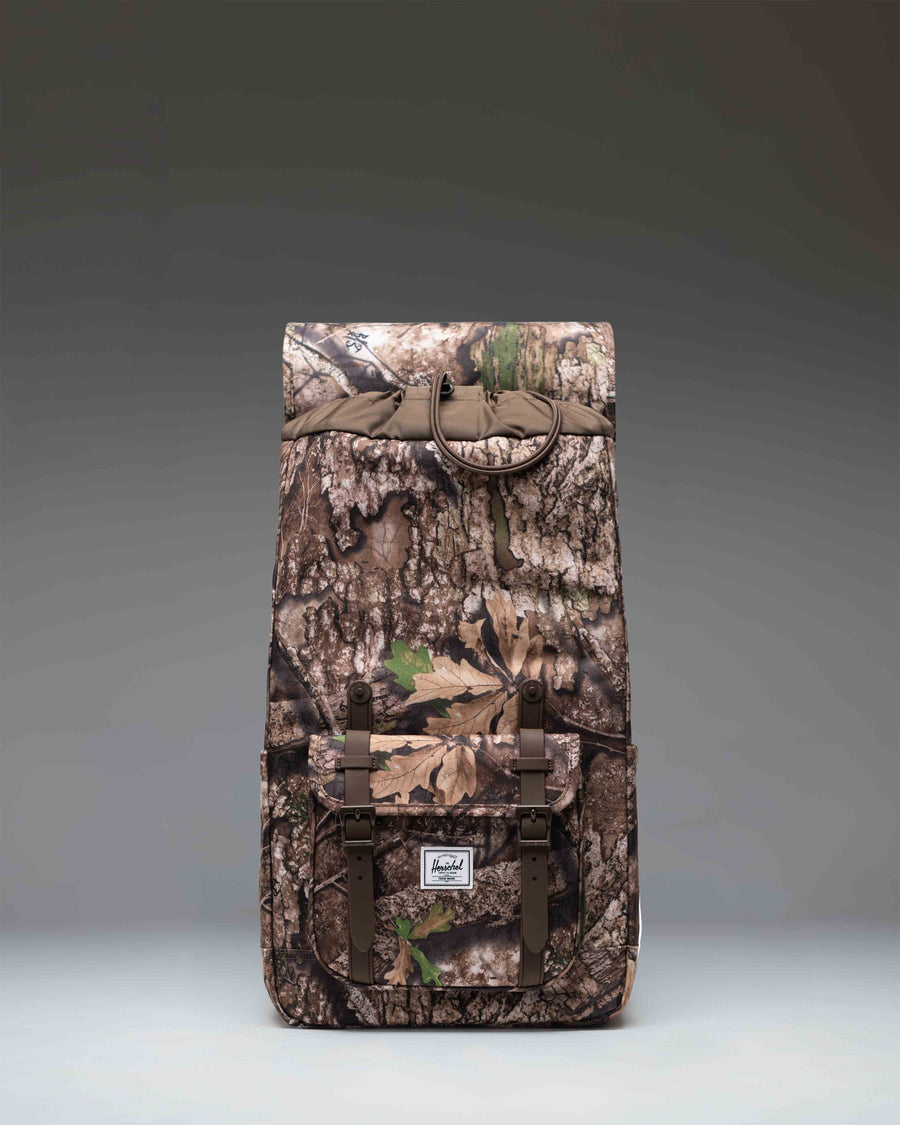 Herschel Supply Co. Realtree Little America Backpack in Realtree APX Camo with signature front straps and a spacious main compartment.