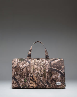 Herschel Supply Co Realtree Novel Duffle bag in Realtree APX Camo pattern, featuring a side shoe compartment.