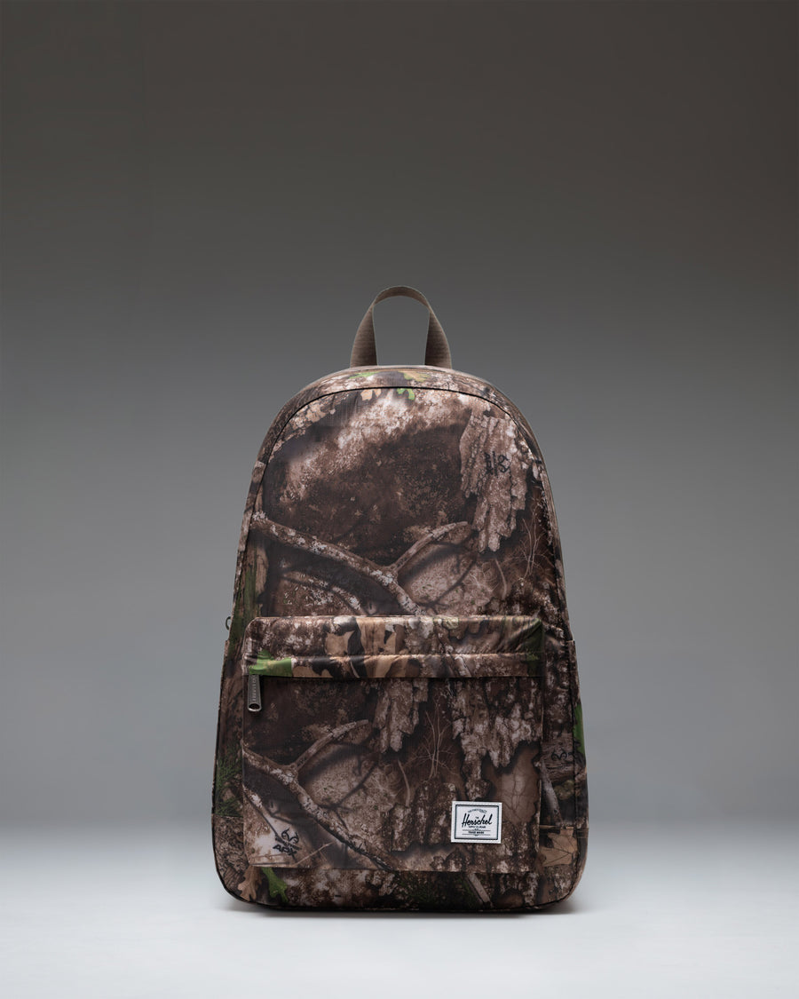 Herschel Supply Co. Realtree Rome Packable Backpack in Realtree APX Camo pattern, showing a lightweight, durable design ideal for travel.