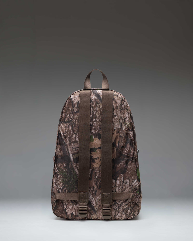 Herschel Supply Co. Realtree Rome Packable Backpack in Realtree APX Camo, showcasing the compact, lightweight design of the unfolded bag.