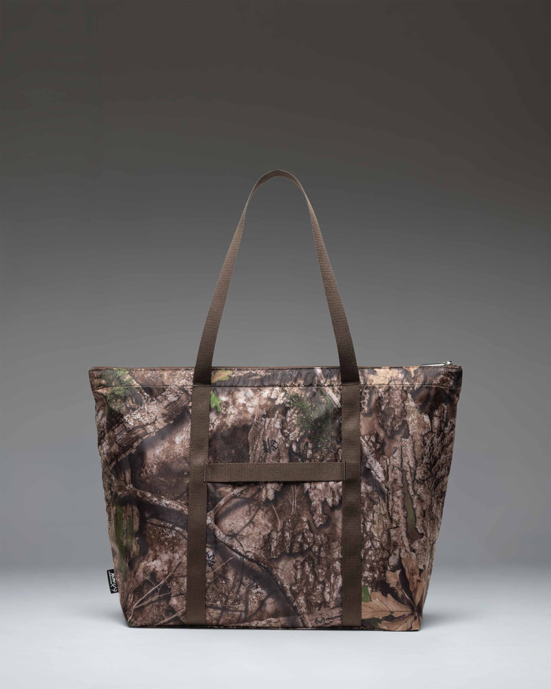 Herschel Supply Co. Portland Packable Tote in Realtree APX Camo shown folded up into its internal pocket for easy, compact storage.