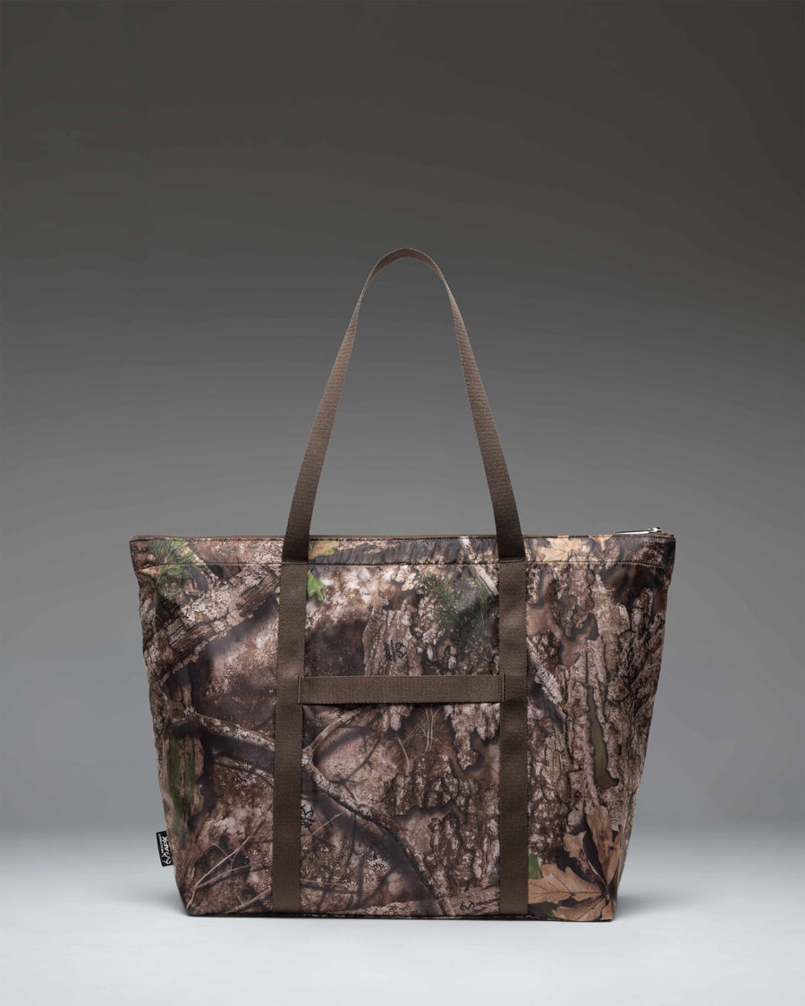 Herschel Supply Co. Portland Packable Tote in Realtree APX Camo shown folded up into its internal pocket for easy, compact storage.