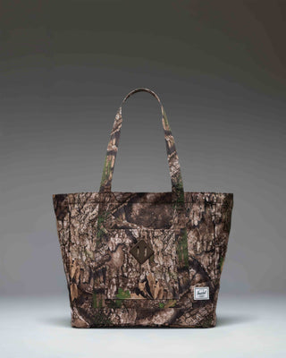 Herschel Heritage Tote bag in Realtree APX camouflage pattern with top-carrying handles and front pocket.