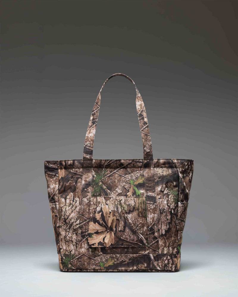 Herschel Heritage Tote bag featuring the Realtree APX camouflage pattern with top carry handles.