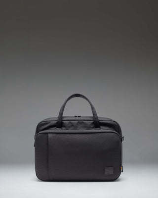 Black Herschel Supply Co. Gibson Messenger Tech Cordura bag showing the front view with handles and adjustable shoulder strap.