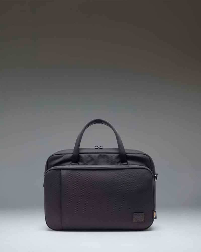 Black Herschel Supply Co. Gibson Messenger Tech Cordura bag showing the front view with handles and adjustable shoulder strap.