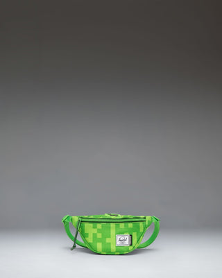 Minecraft Herschel Heritage Hip Pack Little Herschel in Creeper green pixelated pattern, featuring a black adjustable strap and buckle.