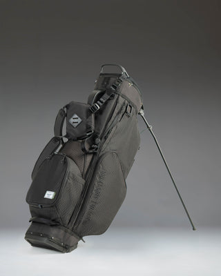 Black Herschel Watt Stand Golf Bag featuring a 5-way top organizer, multiple zippered storage pockets, and a durable fabric construction.