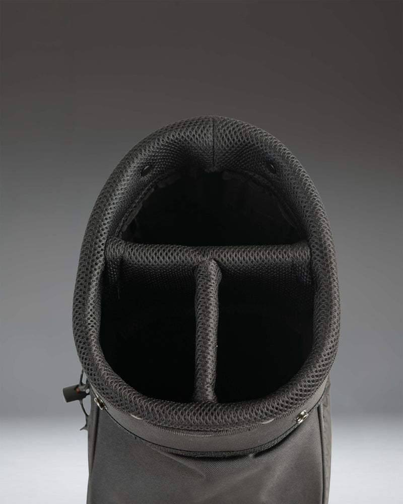 Black Herschel Watt Sunday Bag golf bag showing details of its lightweight design, carrying strap, and storage pockets.