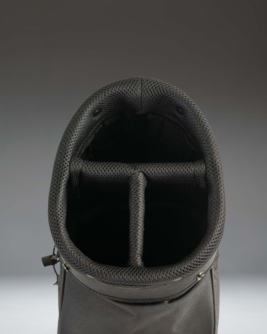 Black Herschel Watt Sunday Bag golf bag showing details of its lightweight design, carrying strap, and storage pockets.