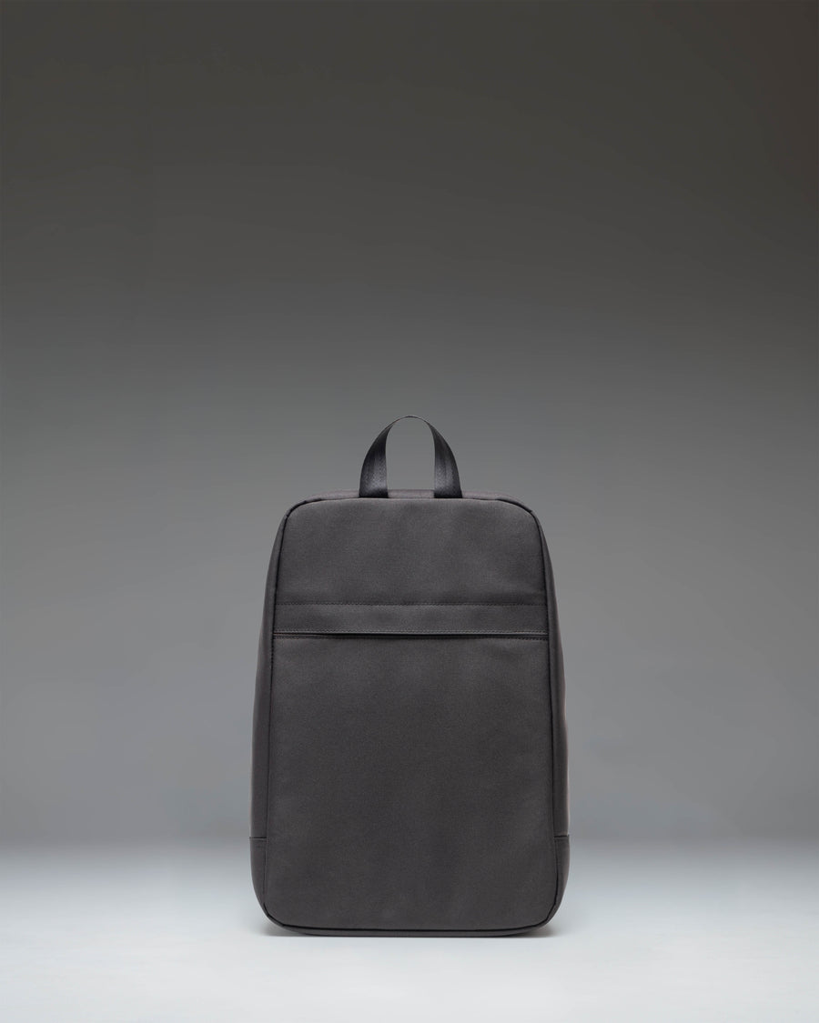 Black Herschel Heritage Shoe Bag showing the back view with a signature diamond detail and carrying handle.