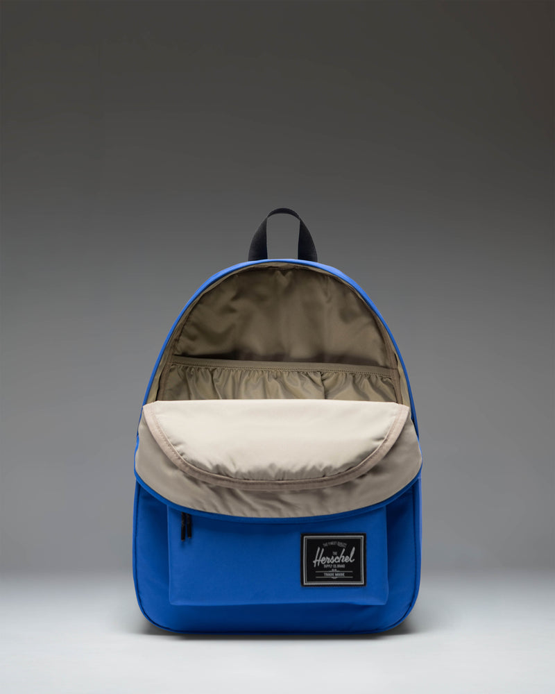 Herschel Classic Backpack Twill in Dazzling Blue, showcasing its clean design, main compartment, and front storage pocket.