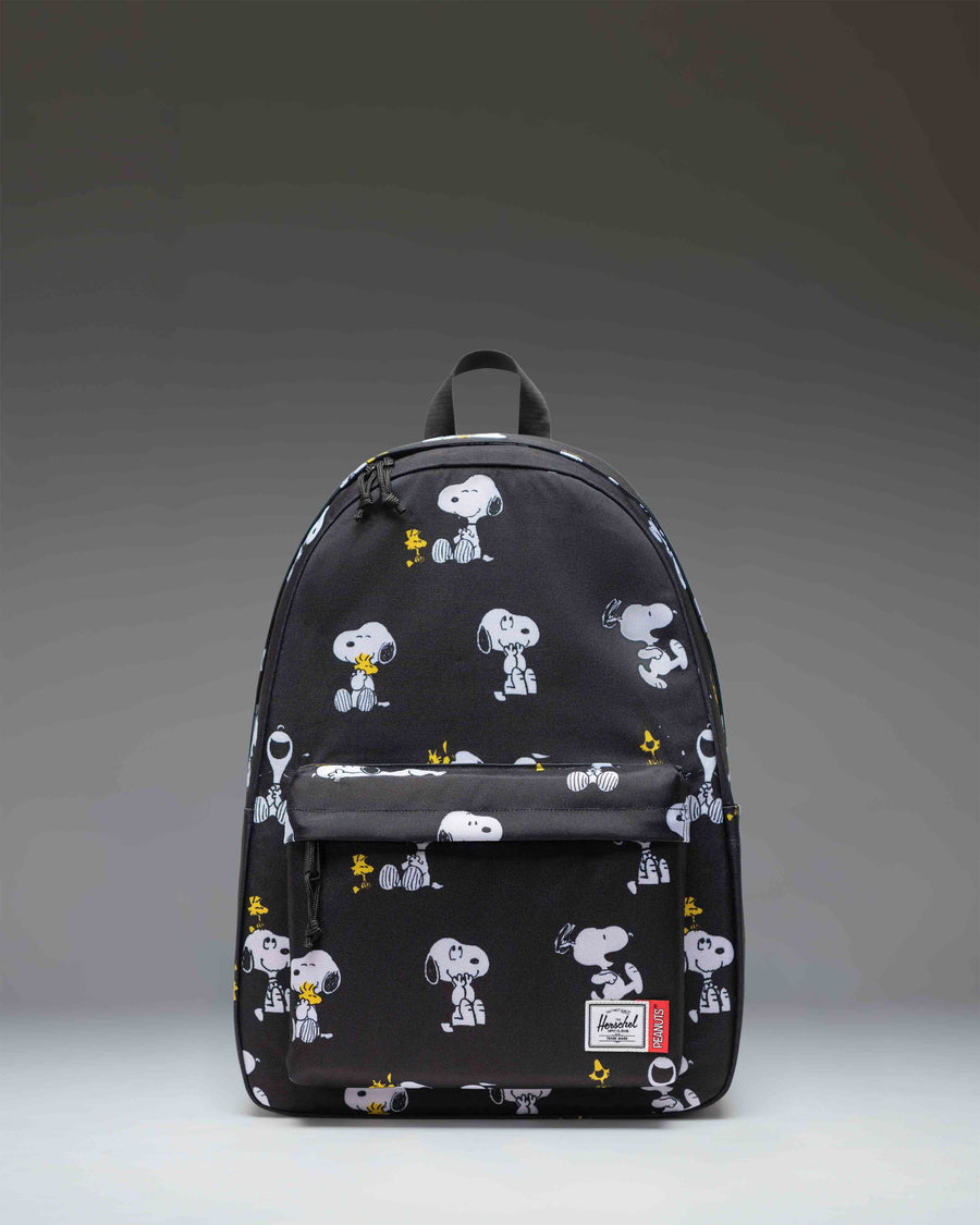 Herschel Supply Co. Peanuts Classic XL Backpack in Snoopy and Woodstock Black featuring a repeating pattern of the classic comic characters.