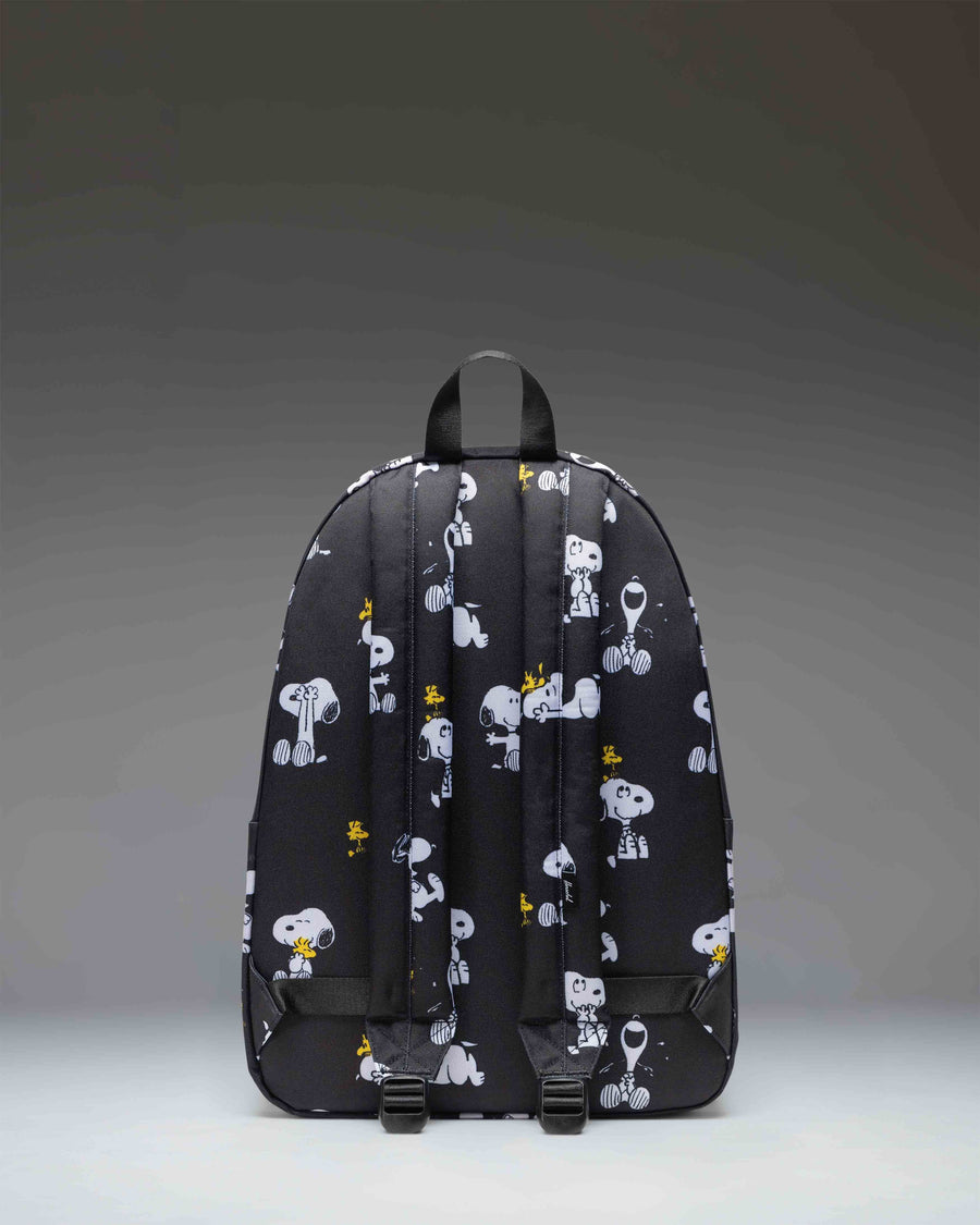 Herschel Classic XL Backpack in Snoopy and Woodstock Black pattern featuring characters printed on a black background.