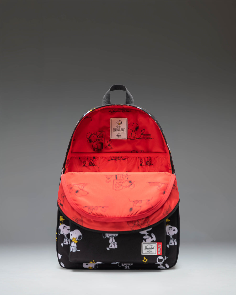 Herschel Supply Co. Peanuts Classic XL Backpack in Snoopy and Woodstock Black featuring an all-over character print.