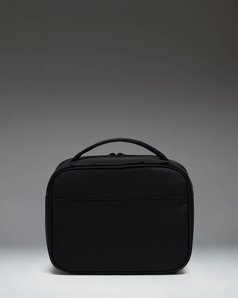 Herschel Supply Co. Pop Quiz Lunch Box in black, showing the insulated main compartment and front pocket.