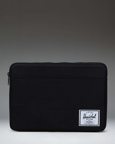 Herschel Supply Co Anchor 14 inch laptop sleeve in black, featuring a clean, minimalist design with a woven brand label.