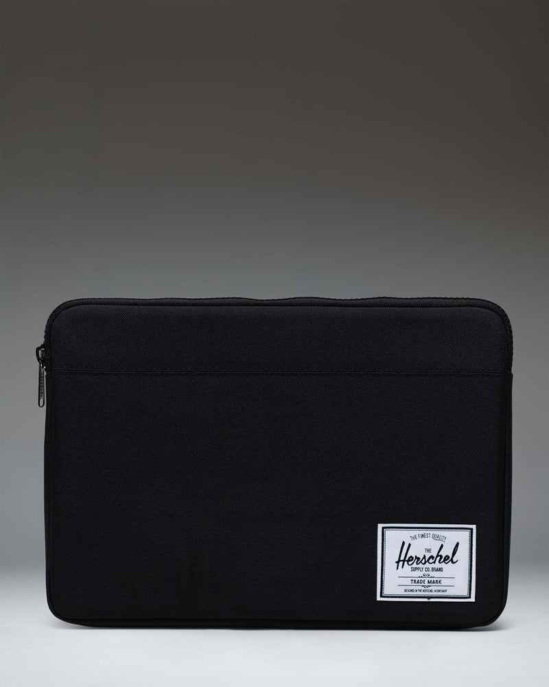 Herschel Supply Co Anchor 14 inch laptop sleeve in black, featuring a clean, minimalist design with a woven brand label.