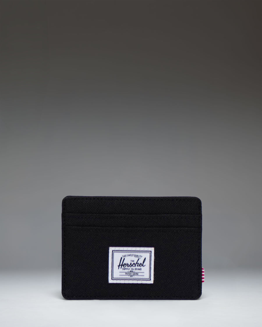 Herschel Supply Co. Charlie Cardholder wallet in solid black featuring multiple card slots and the signature woven label.