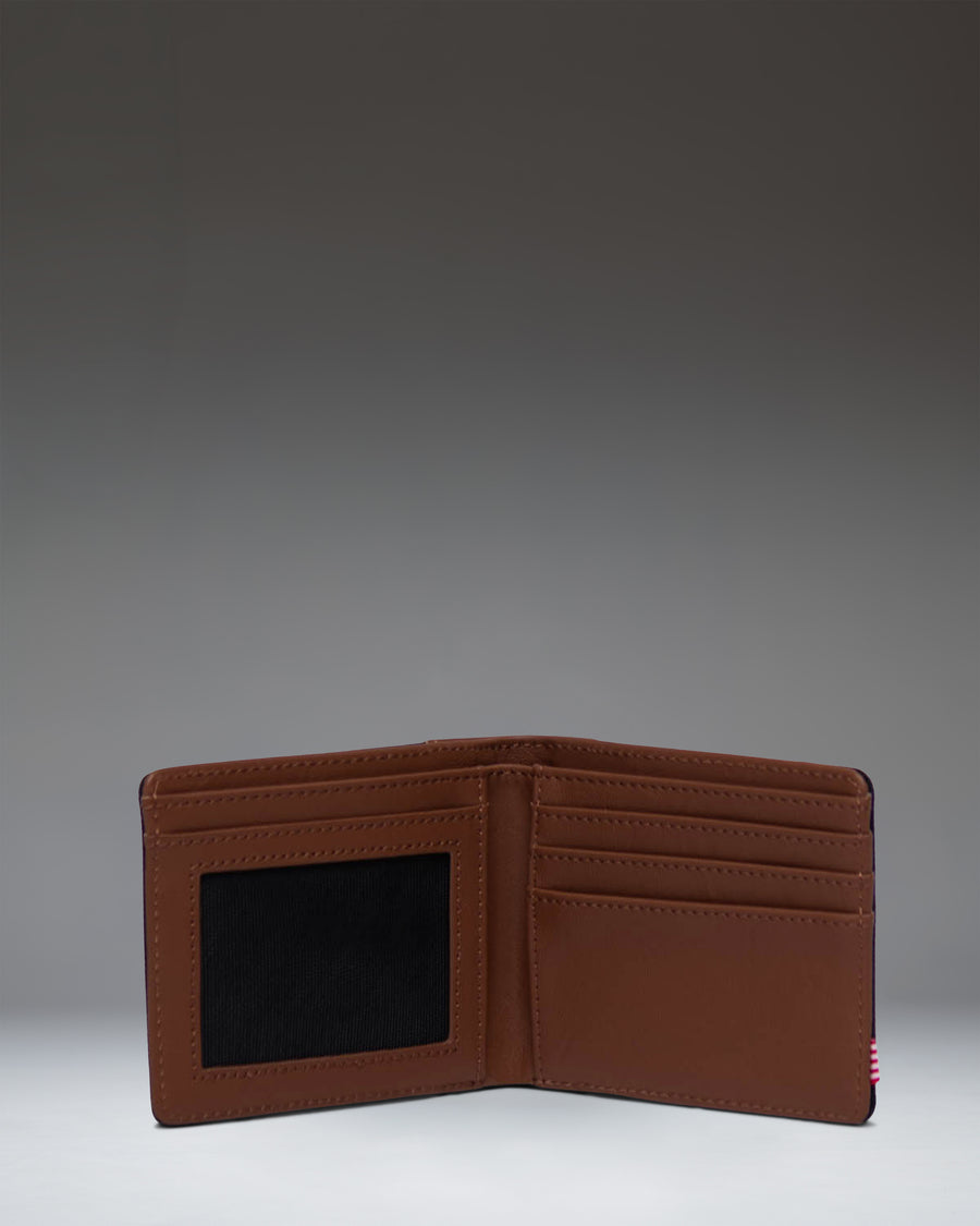 Herschel Supply Co. Hank Wallet in Black/Tan, open to show the tan interior with card slots and currency sleeve.