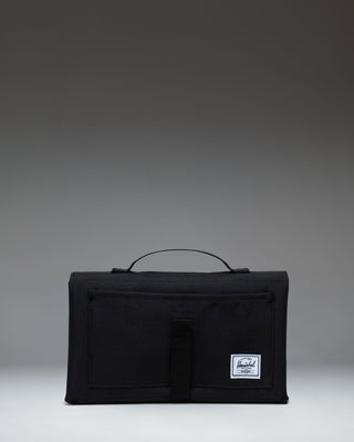 Black Herschel Supply Co. Sprout Change Mat, unfolded to show the padded mat surface and mesh storage pockets for baby essentials.