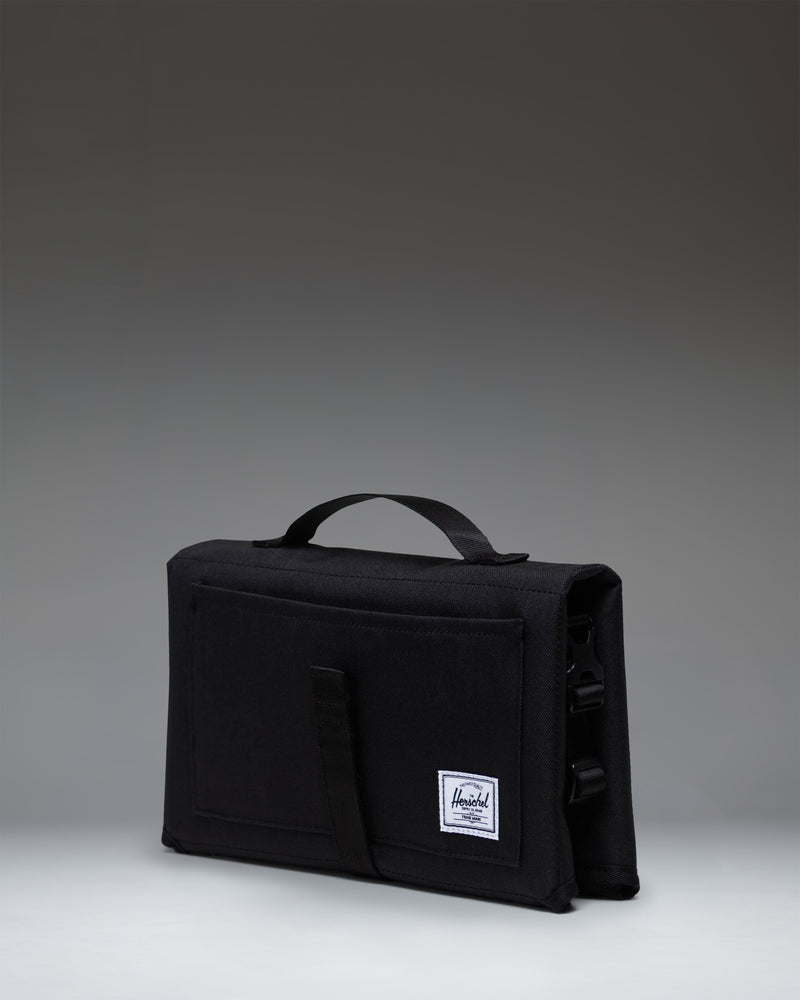 Herschel Supply Co Sprout Change Mat in black, shown fully unfolded and laid flat.