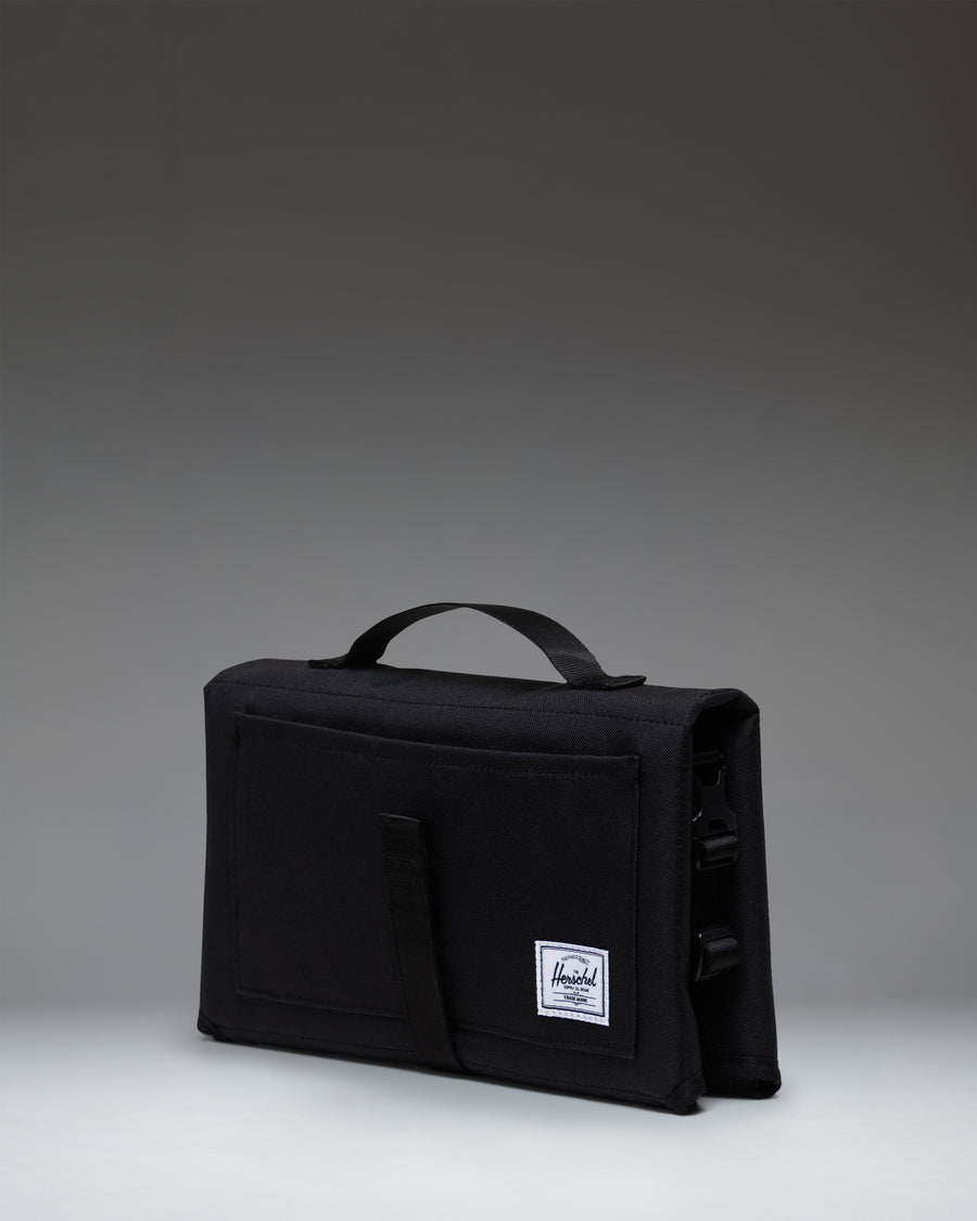 Herschel Supply Co Sprout Change Mat in black, shown fully unfolded and laid flat.