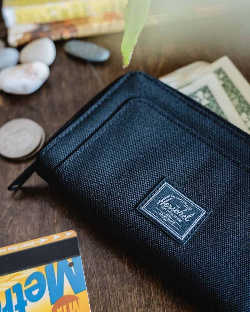 Herschel Supply Co. Thomas Wallet. This clutch-style wallet organizes cards, currency, and coins with a secure zippered closure.