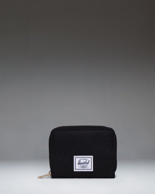 Herschel Supply Co Tyler Wallet in black, displaying a classic zippered design with the signature woven label on the front.