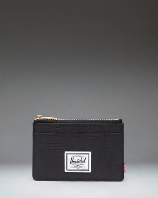 Herschel Supply Co. Oscar Cardholder in black, showing a sleek, compact design with multiple card slots and the classic woven brand label.