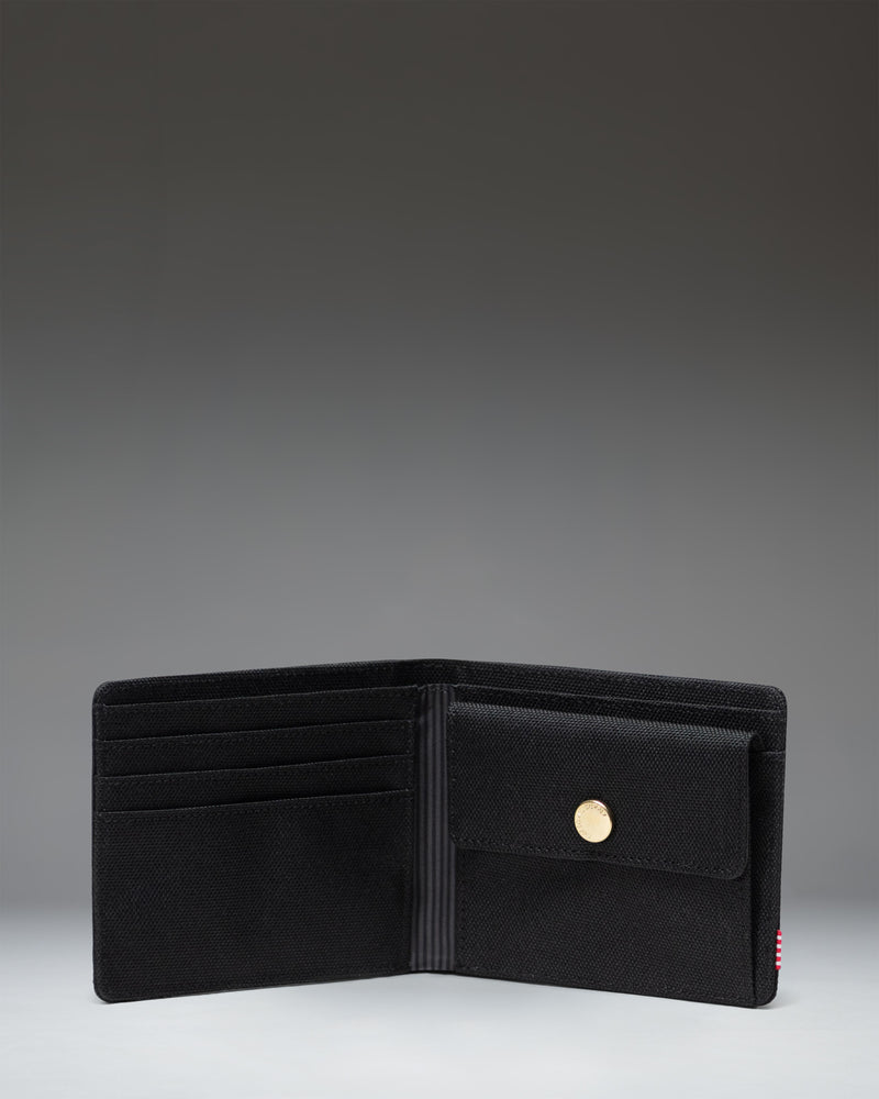 Herschel Supply Co Roy Coin Wallet in black, showing the classic bi-fold design with an exterior coin pocket and internal card slots.