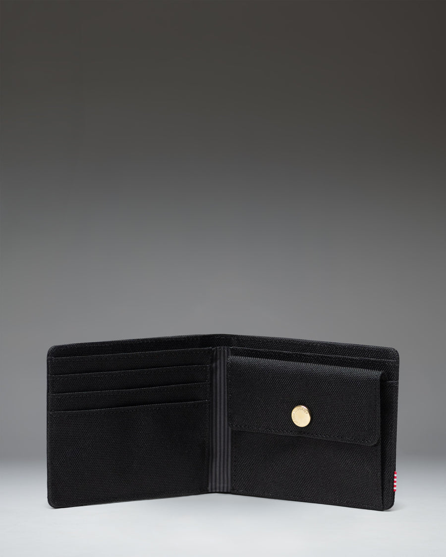 Herschel Supply Co Roy Coin Wallet in black, showing the classic bi-fold design with an exterior coin pocket and internal card slots.