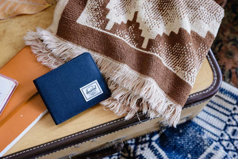 Herschel Supply Co. Roy Coin Wallet in Raven Crosshatch, showing a bi-fold design with internal slots and a coin pocket.