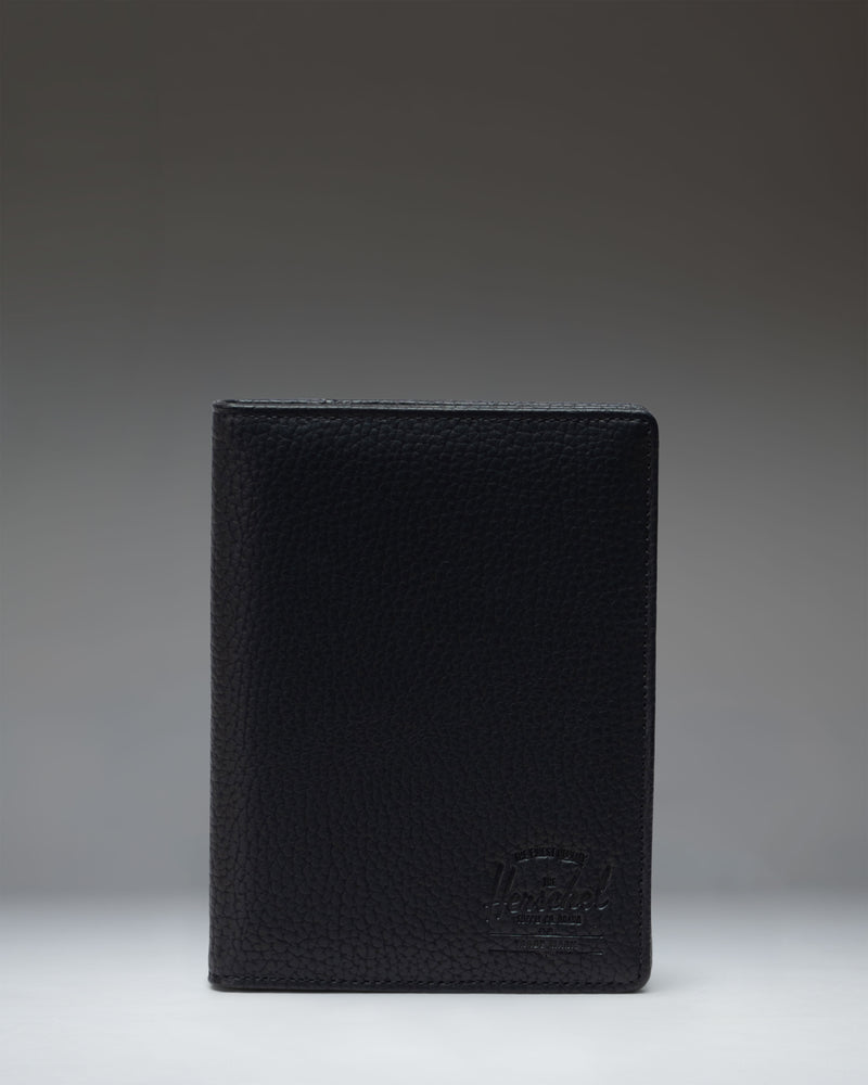 Black Herschel Supply Co. Raynor Passport Holder made from vegan leather.