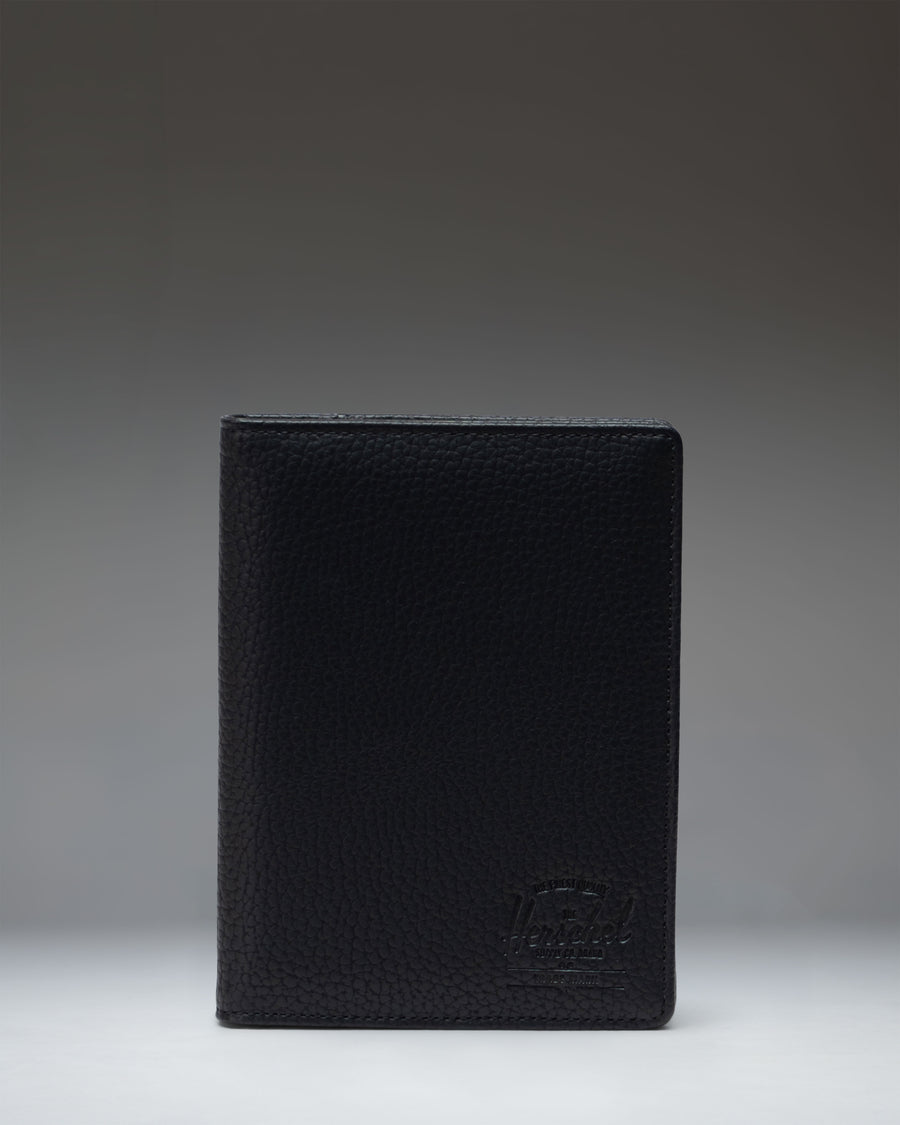 Black Herschel Supply Co. Raynor Passport Holder made from vegan leather.