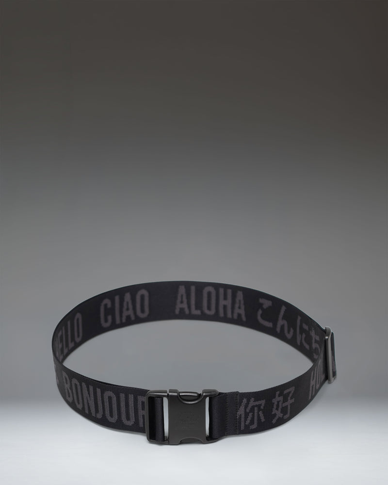 Black adjustable Herschel Supply Co luggage belt with a quick-release buckle, designed to secure bags and suitcases.