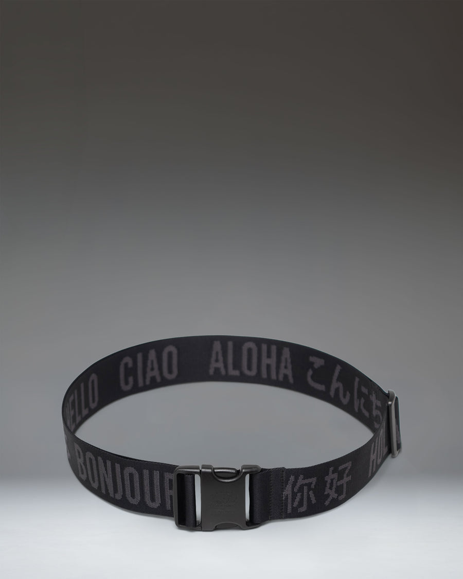 Black adjustable Herschel Supply Co luggage belt with a quick-release buckle, designed to secure bags and suitcases.