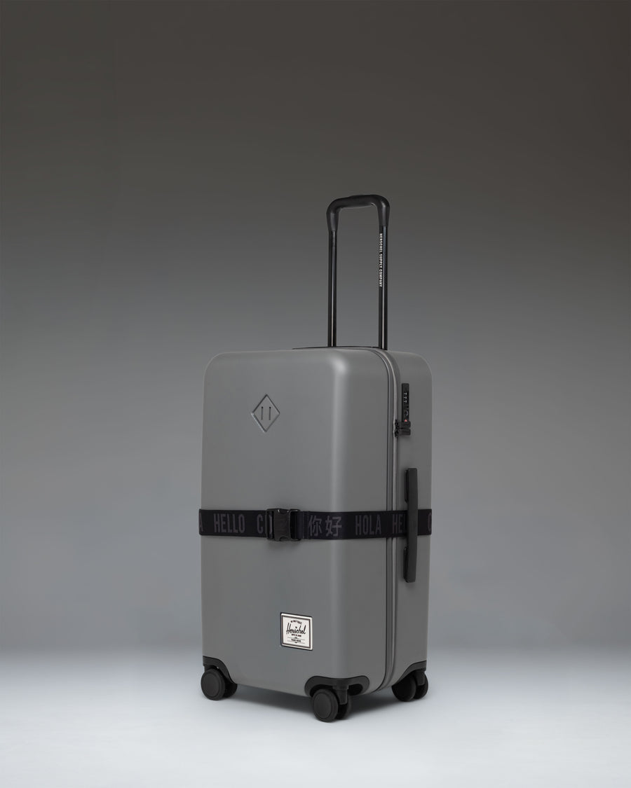 Herschel Supply Co. Black Luggage Belt laid out flat, featuring a durable adjustable strap and a prominent black buckle with subtle branding.