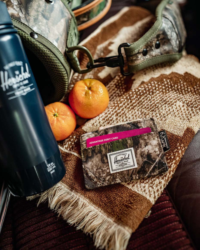 Herschel Supply Co. Realtree Charlie Cardholder wallet displayed in multiple color options.